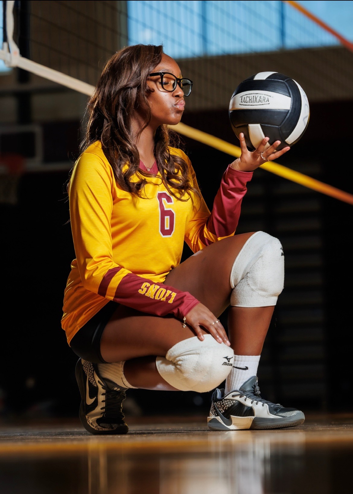 Kadence holding a volleyball in her uniform